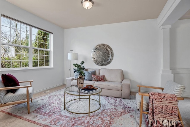 living room featuring baseboards and visible vents