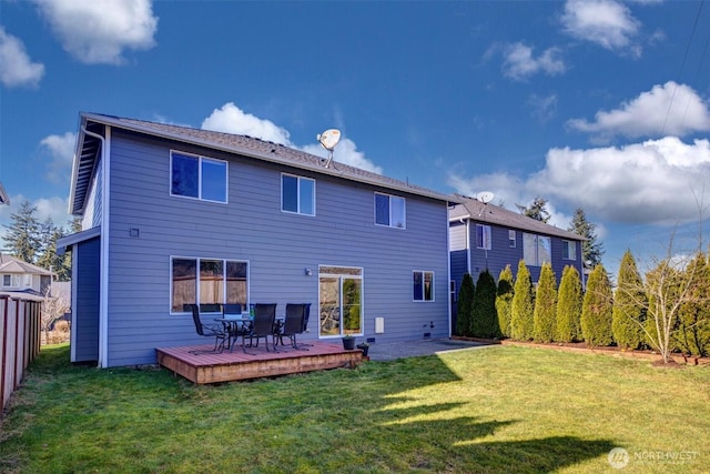 back of property featuring a yard and a wooden deck