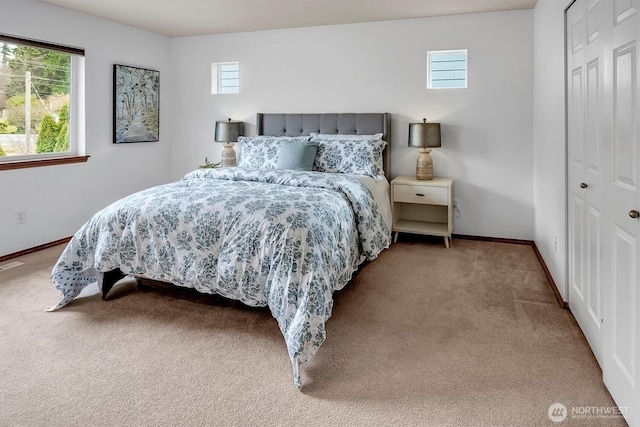 bedroom featuring a closet, carpet flooring, and baseboards