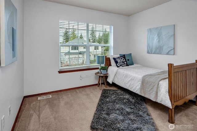 bedroom featuring carpet floors, visible vents, and baseboards