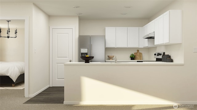 kitchen featuring under cabinet range hood, stove, white cabinetry, light countertops, and stainless steel fridge