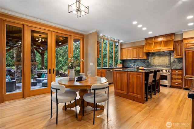 dining room with visible vents, ornamental molding, french doors, light wood-style floors, and recessed lighting