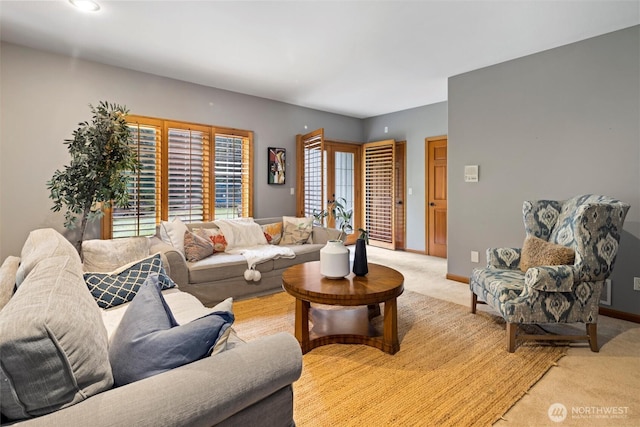 living room with light carpet and baseboards