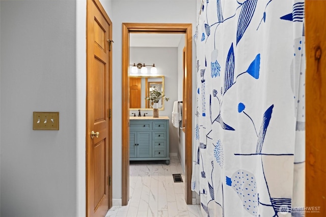 bathroom with marble finish floor, vanity, visible vents, and a shower with shower curtain