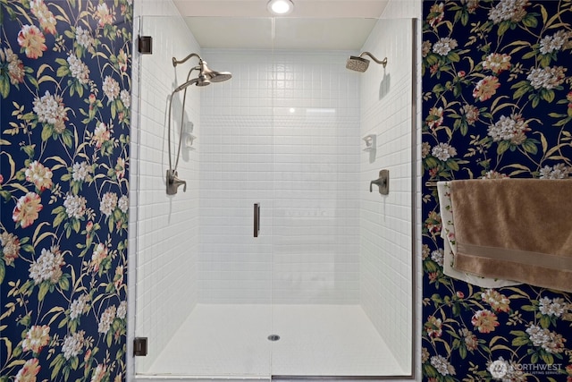 full bath featuring a shower stall and wallpapered walls