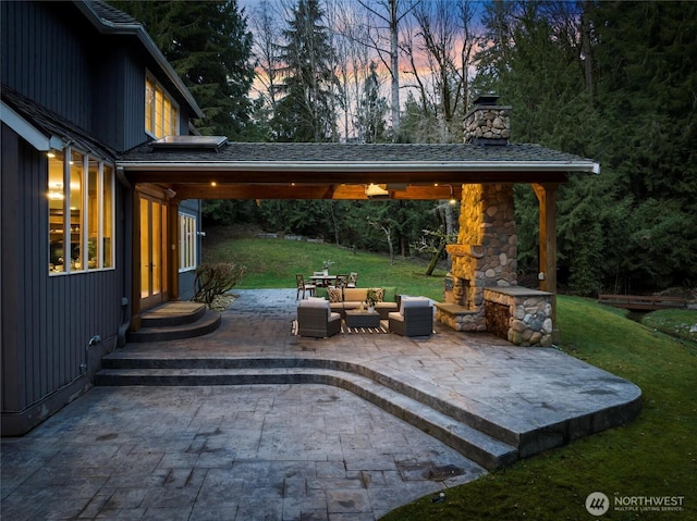 view of patio with an outdoor living space with a fireplace