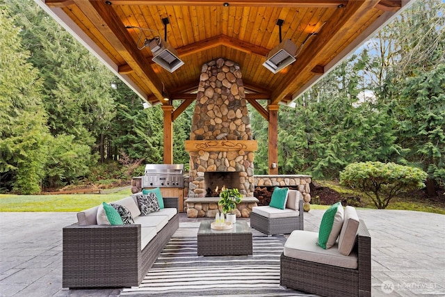 view of patio / terrace with an outdoor living space with a fireplace and a grill