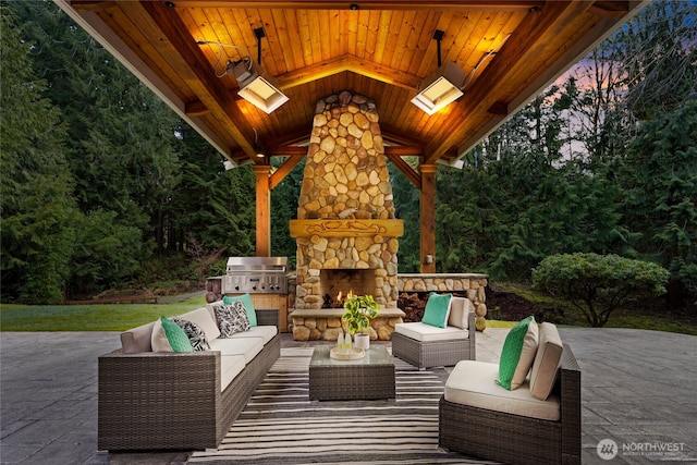 view of patio featuring an outdoor living space with a fireplace and grilling area