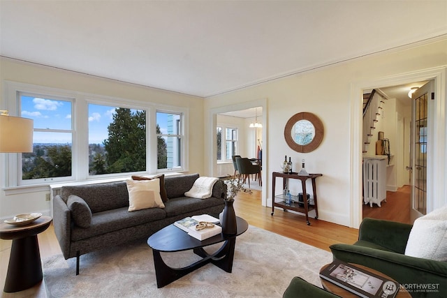 living area featuring radiator heating unit and light wood-style flooring