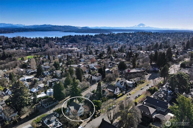 bird's eye view with a residential view and a water and mountain view