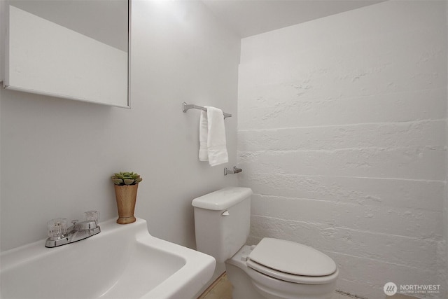 bathroom featuring toilet and a sink