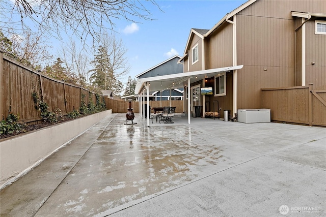 exterior space with a patio area, a fenced backyard, and outdoor dining space