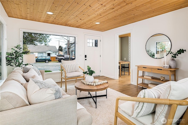 living area featuring recessed lighting, wood ceiling, baseboards, and wood finished floors