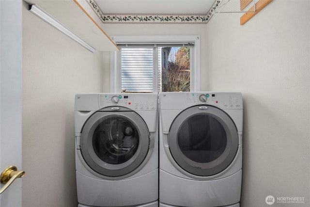 clothes washing area featuring laundry area and washing machine and dryer