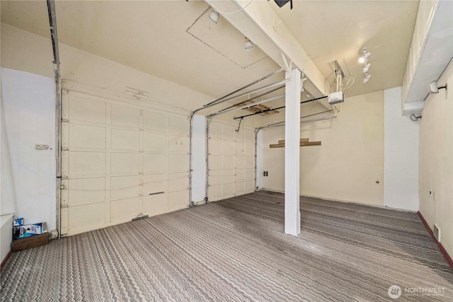 garage with a garage door opener and visible vents