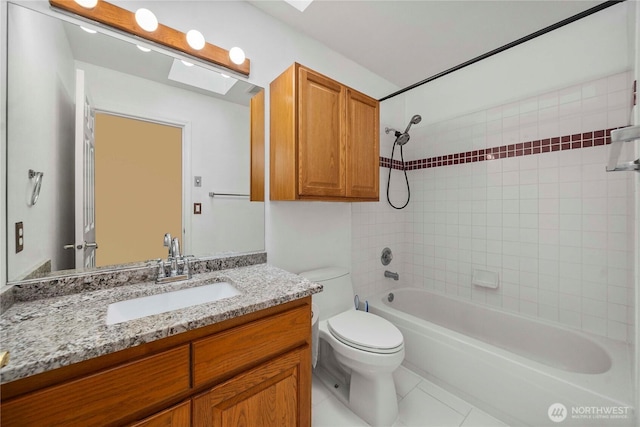 bathroom with tile patterned floors, shower / bathing tub combination, toilet, and vanity