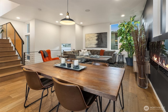 dining room featuring stairway, recessed lighting, and light wood-style floors