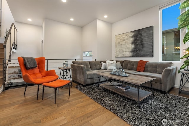 living area with light wood-type flooring and recessed lighting