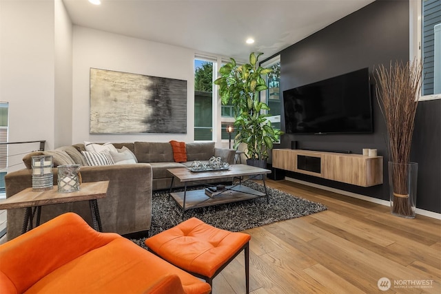 living room with light wood finished floors and recessed lighting