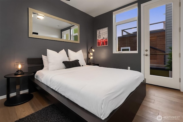 bedroom with baseboards and wood finished floors