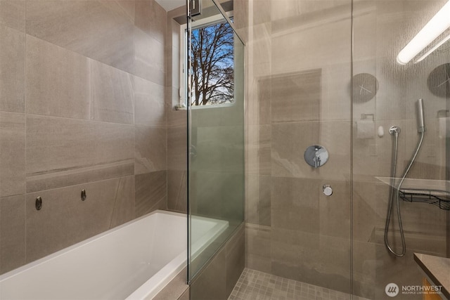 full bathroom with a washtub and a tile shower