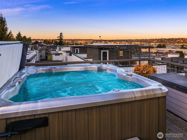 view of swimming pool with a hot tub and a deck