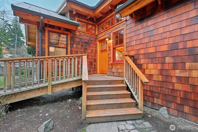 doorway to property featuring a standing seam roof and metal roof