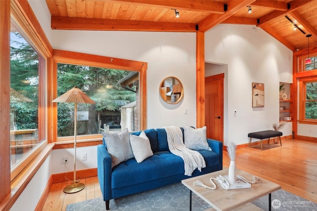 living room with baseboards, wooden ceiling, hardwood / wood-style floors, vaulted ceiling with beams, and track lighting