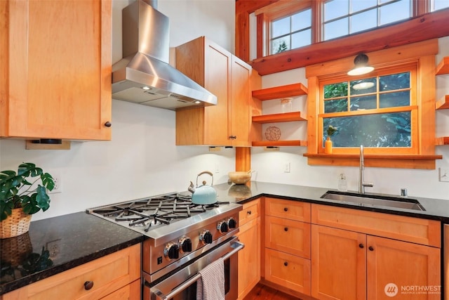 kitchen featuring island exhaust hood, open shelves, a sink, dark stone counters, and high end stove