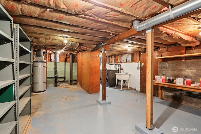 unfinished basement with a sink and washer and dryer