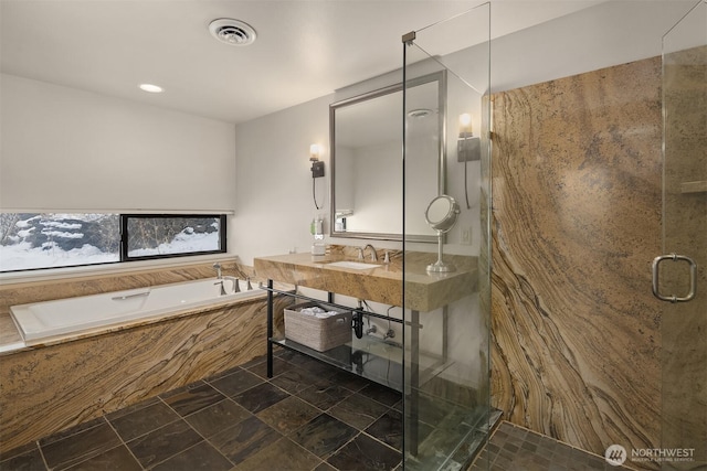 bathroom featuring a stall shower, visible vents, a garden tub, and vanity