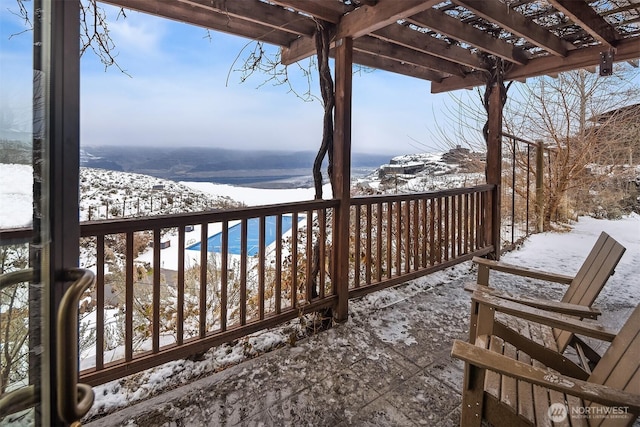 snow covered deck featuring a pergola