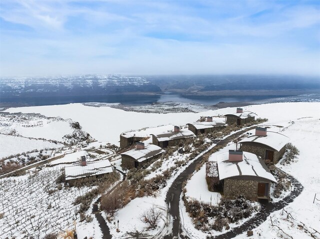 snowy aerial view with a water view