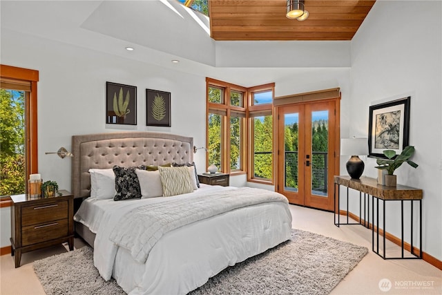 bedroom with access to outside, baseboards, french doors, and carpet