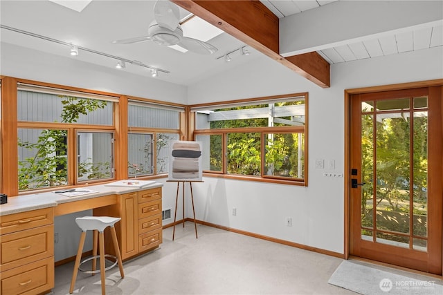 office space featuring visible vents, baseboards, built in study area, ceiling fan, and rail lighting