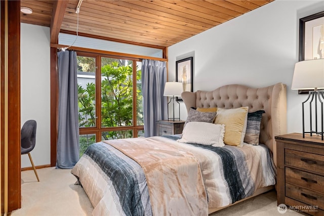 bedroom with baseboards, wood ceiling, and carpet