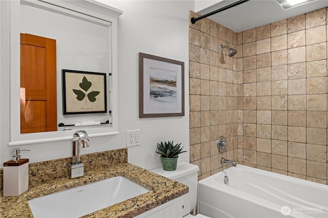 bathroom featuring toilet, shower / bathing tub combination, and vanity
