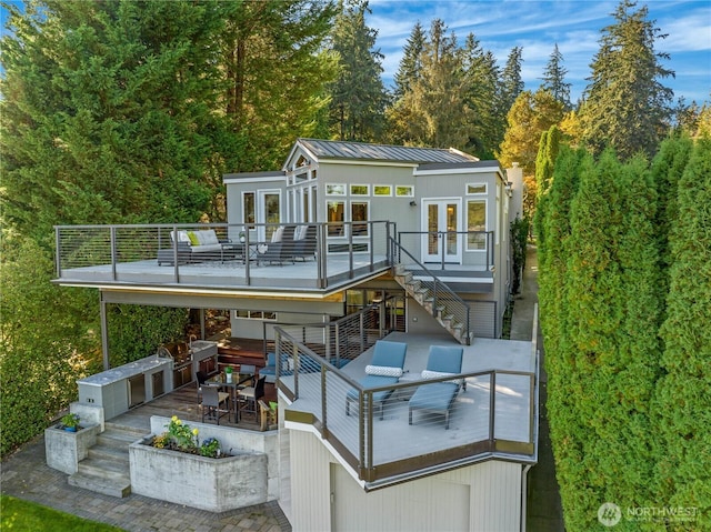 back of property featuring stairs, french doors, and a deck