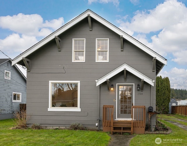 rear view of property with a yard