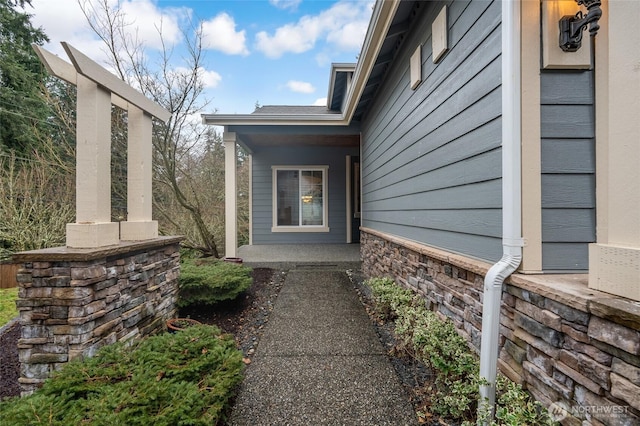 view of exterior entry with a porch