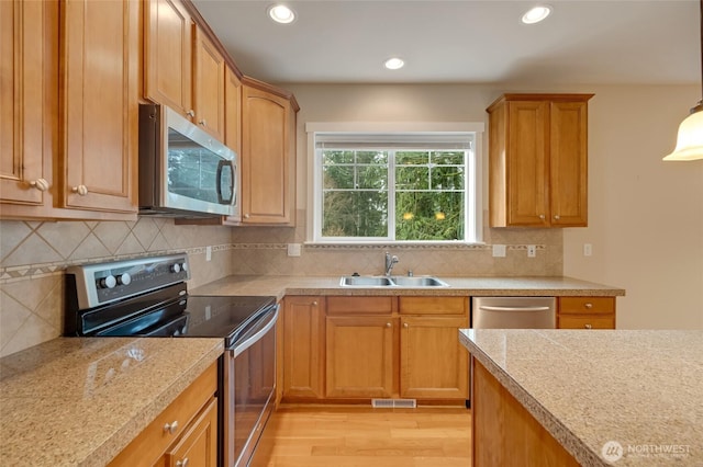 kitchen with visible vents, light countertops, recessed lighting, appliances with stainless steel finishes, and a sink