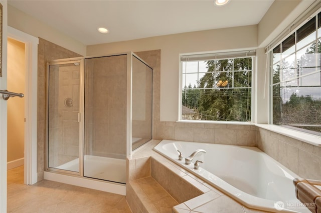 full bath featuring tile patterned flooring, recessed lighting, a stall shower, and a garden tub