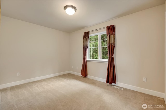 unfurnished room featuring visible vents, baseboards, and light colored carpet