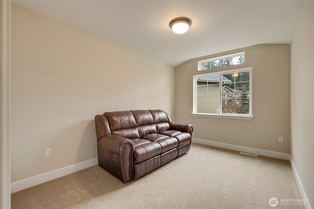 sitting room with vaulted ceiling, baseboards, and carpet floors