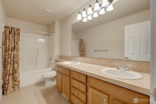 bathroom with a sink, visible vents, toilet, and tile patterned floors