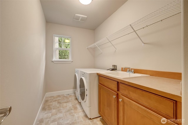 laundry room featuring visible vents, washer and dryer, a sink, cabinet space, and baseboards