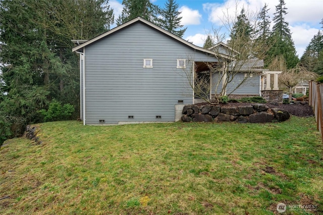 exterior space featuring crawl space, a lawn, and fence