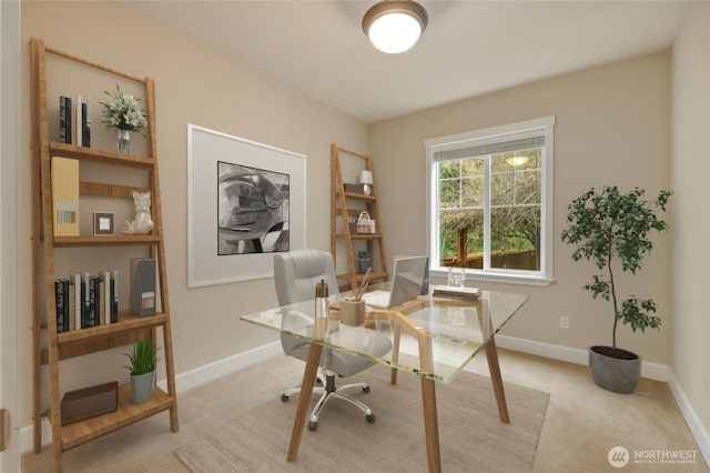 office with baseboards and light carpet