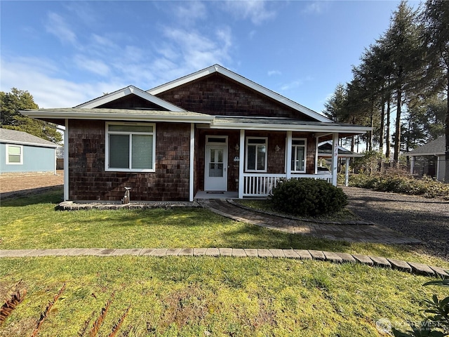 view of front of home featuring a front yard and covered porch