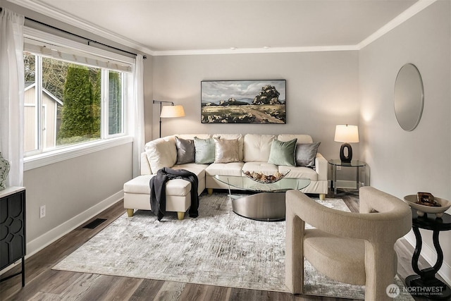 living area featuring crown molding, baseboards, and wood finished floors